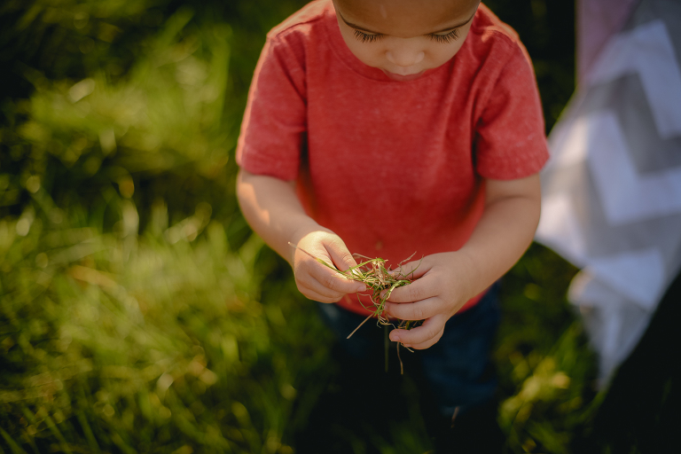 child playing with grass