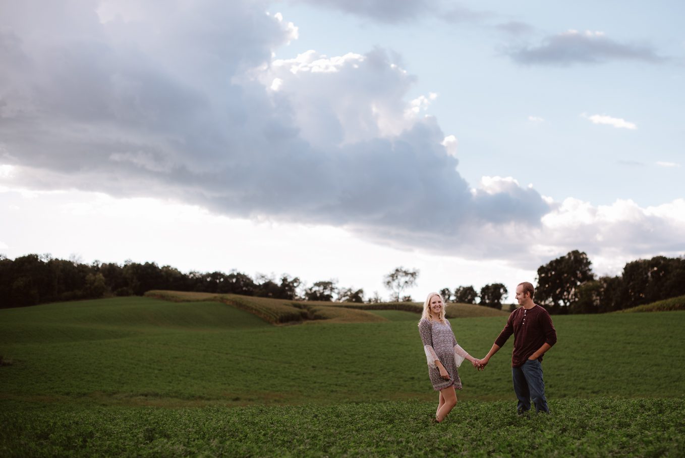 Stormy clouds in Wisconsin field during engagement session.