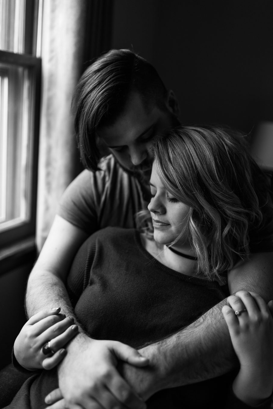 black and white portrait of couple in dramatic window light
