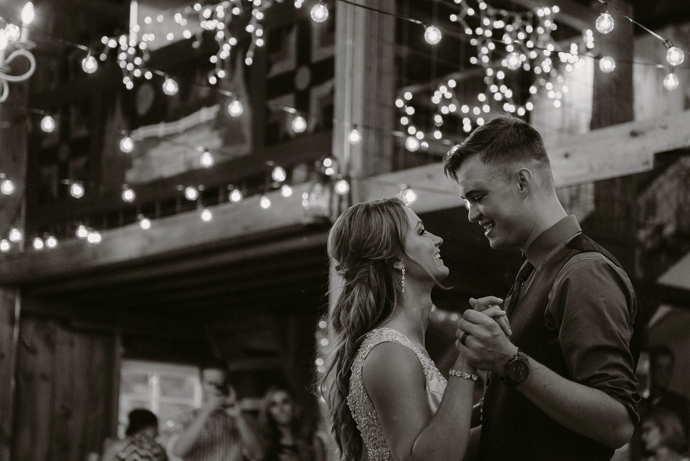 Wedding couples first dance in the barn