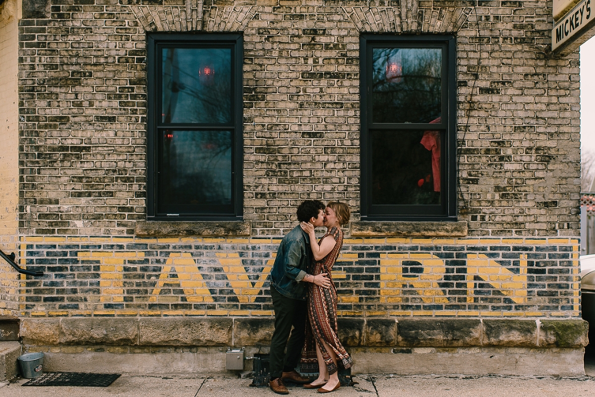 Couple kissing in front of Micky's Tavern in Madison