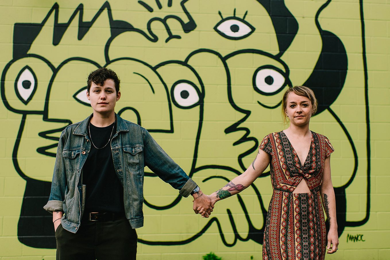 hipster pose in front of grafiti on willy st