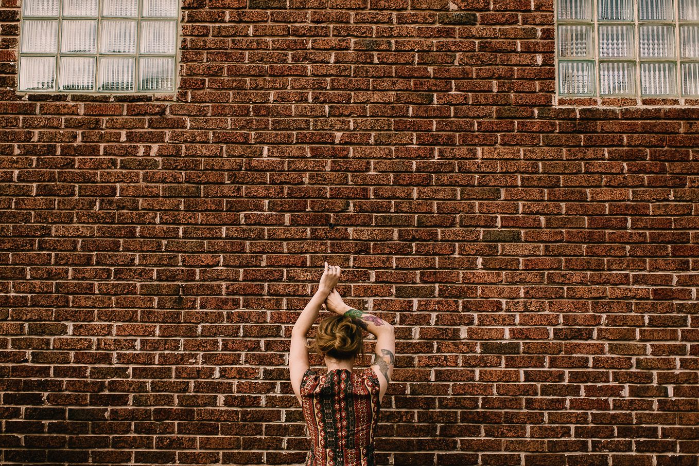 girl with tattoos in front of crystal corner bar