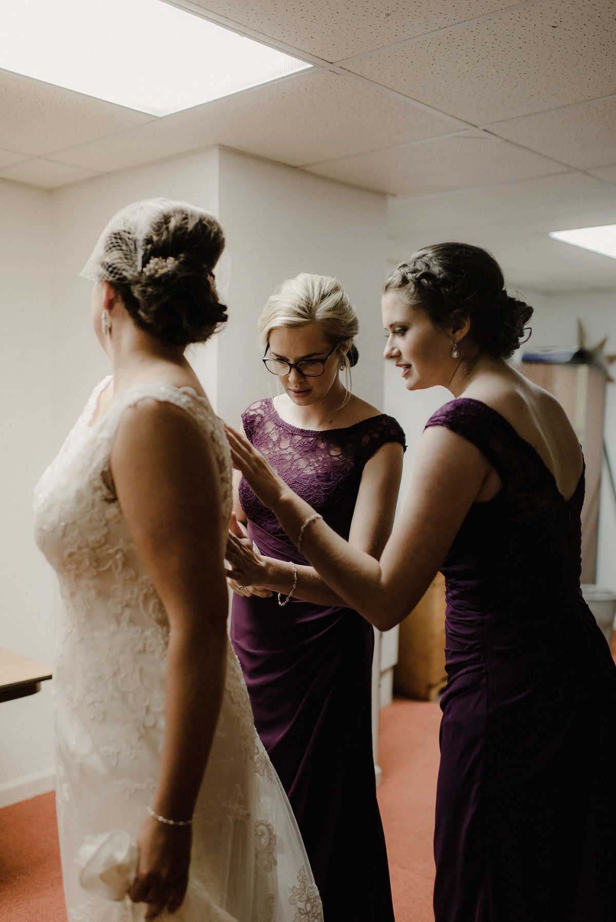 Bridgesmaids complimenting bride and her dress