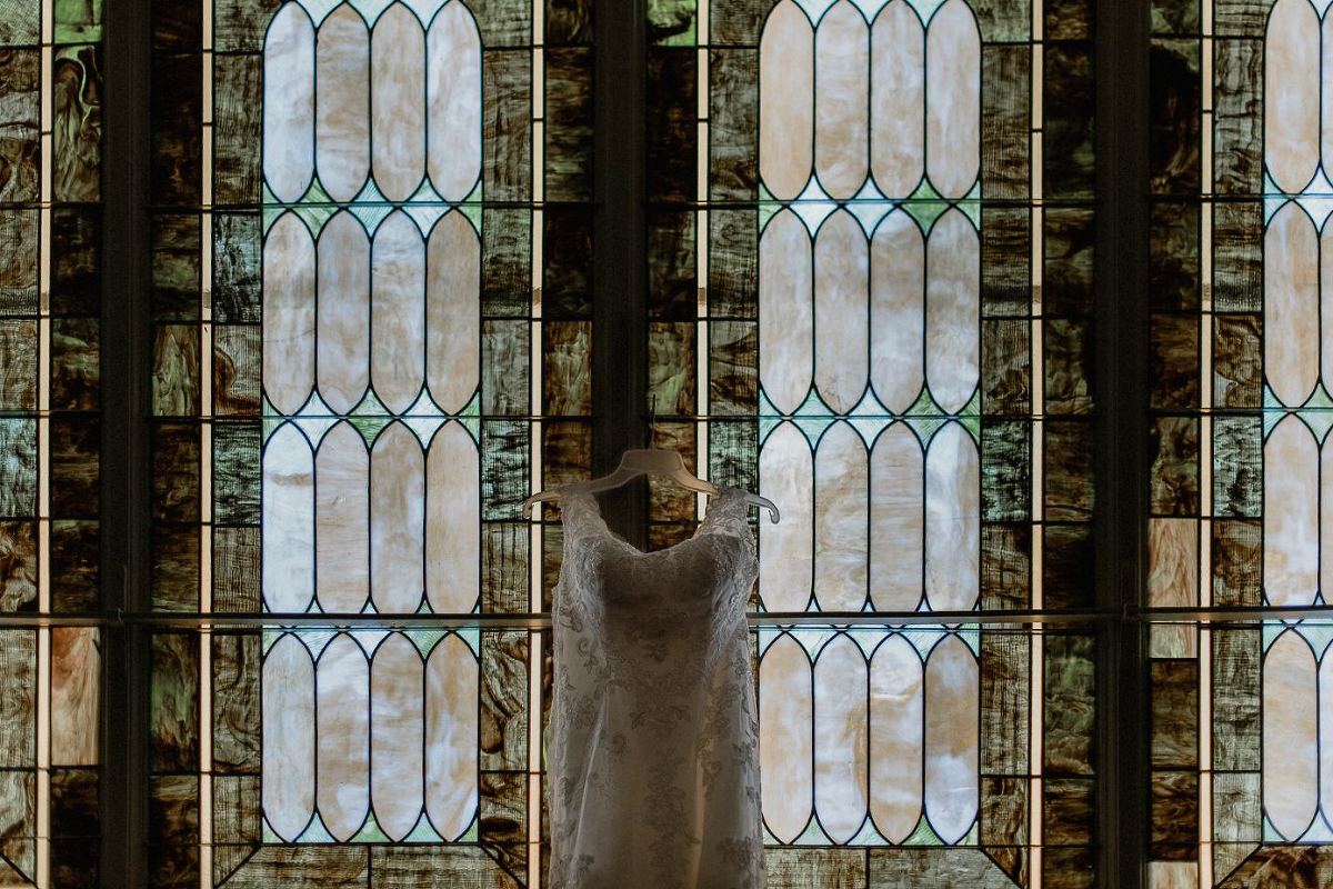 Bridal gown against stained glass windows