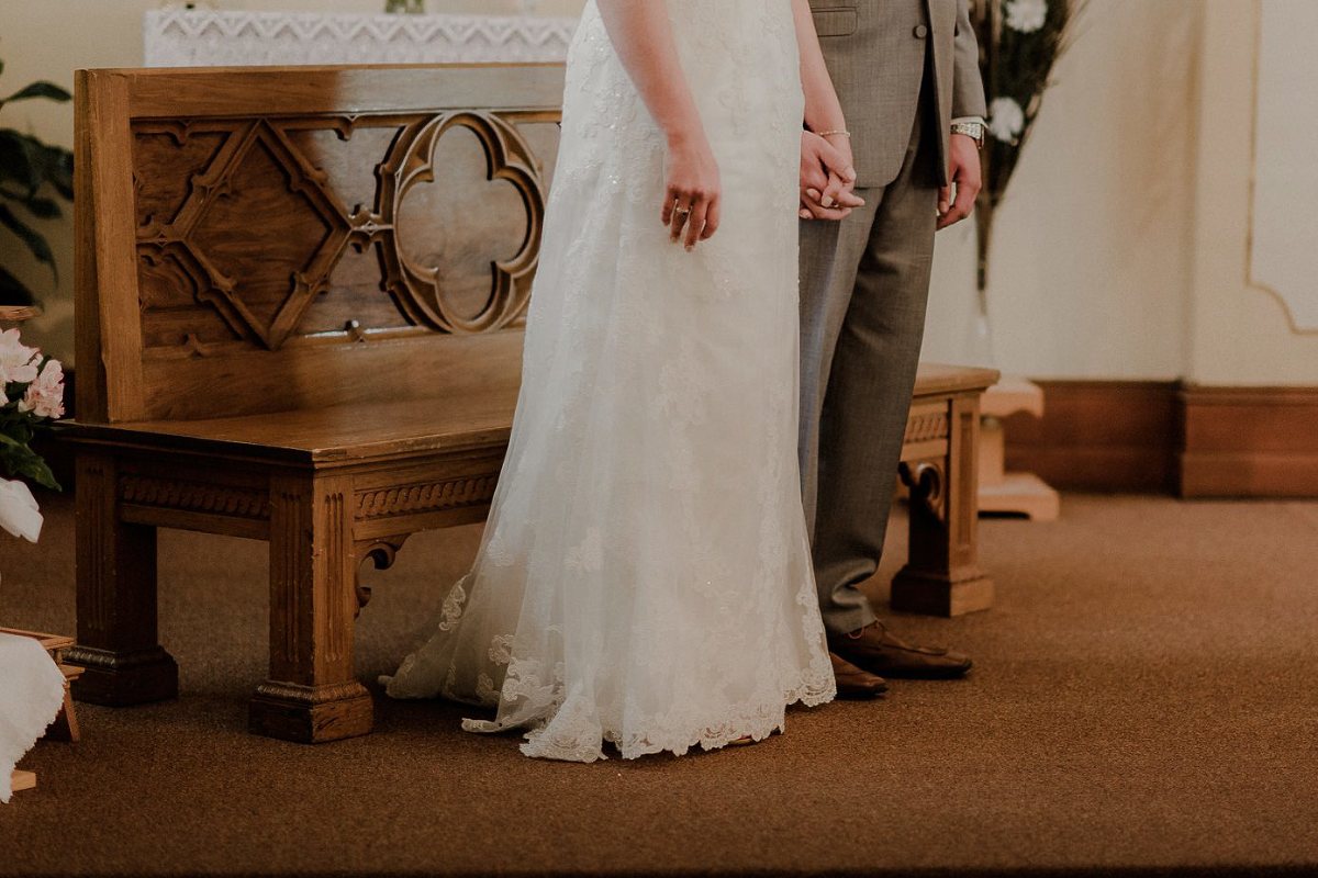 Couple holding hands in church