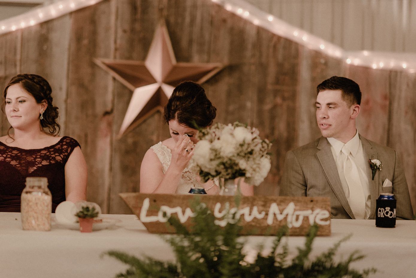 Bride wiping a tear during her father's speach