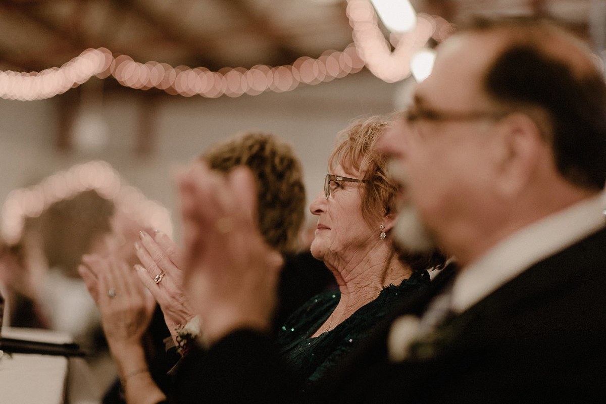 Grandmother aplauding father after he gave a toast