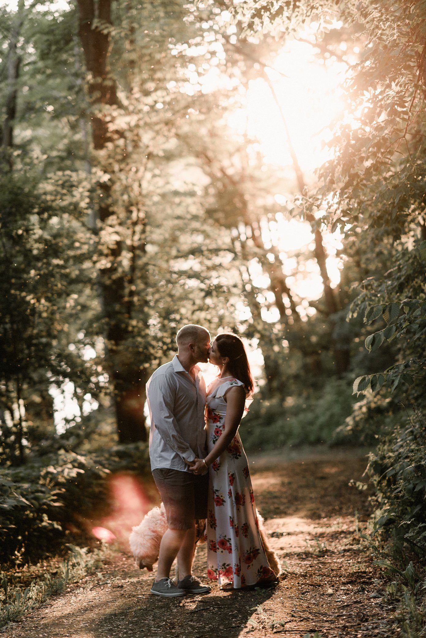 Couple kissing at engagement session during golden hour