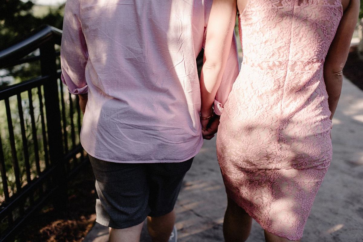 Couple walking hand in hand on WIS Dells River Walk