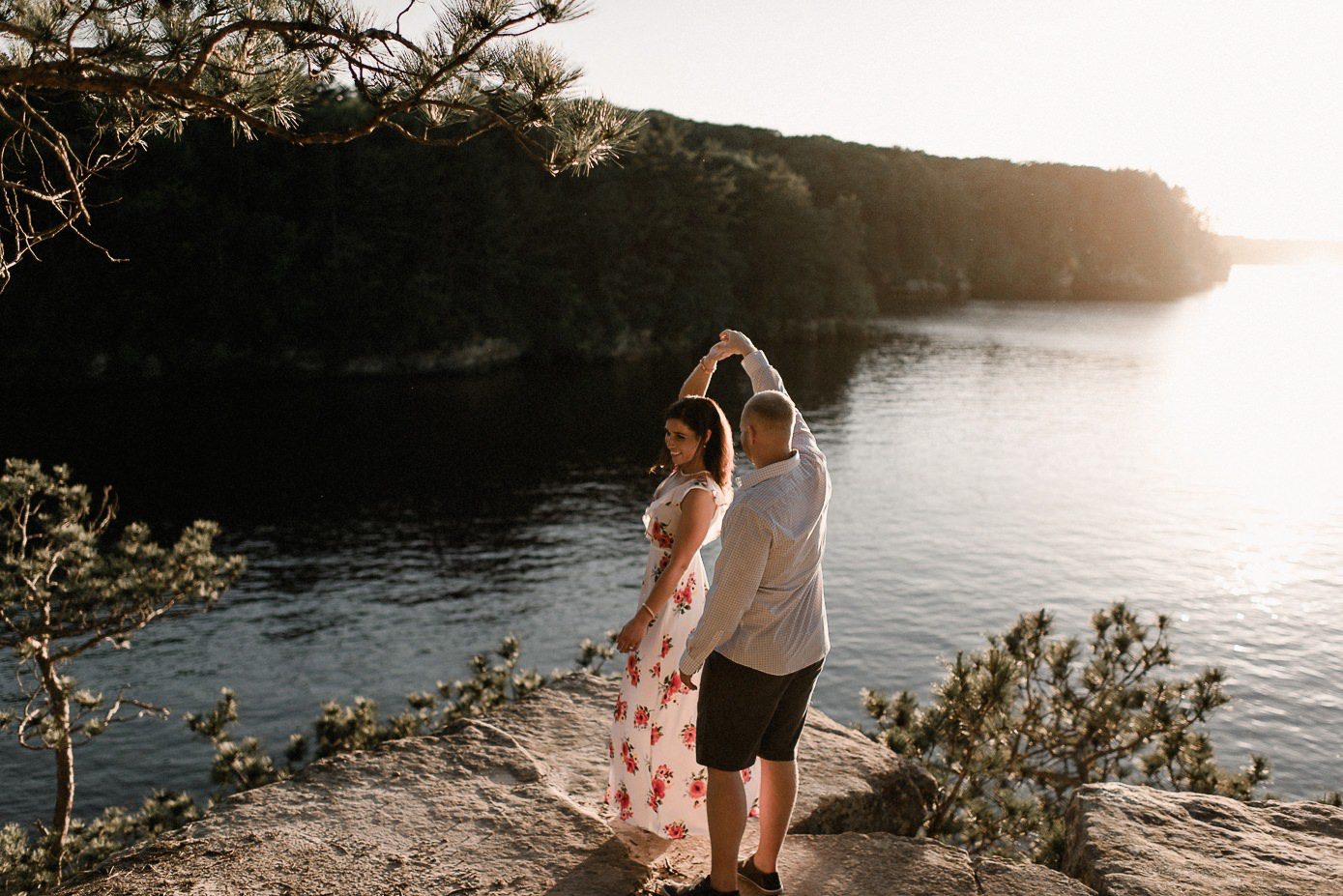 twirling fiance on top of sunset rock