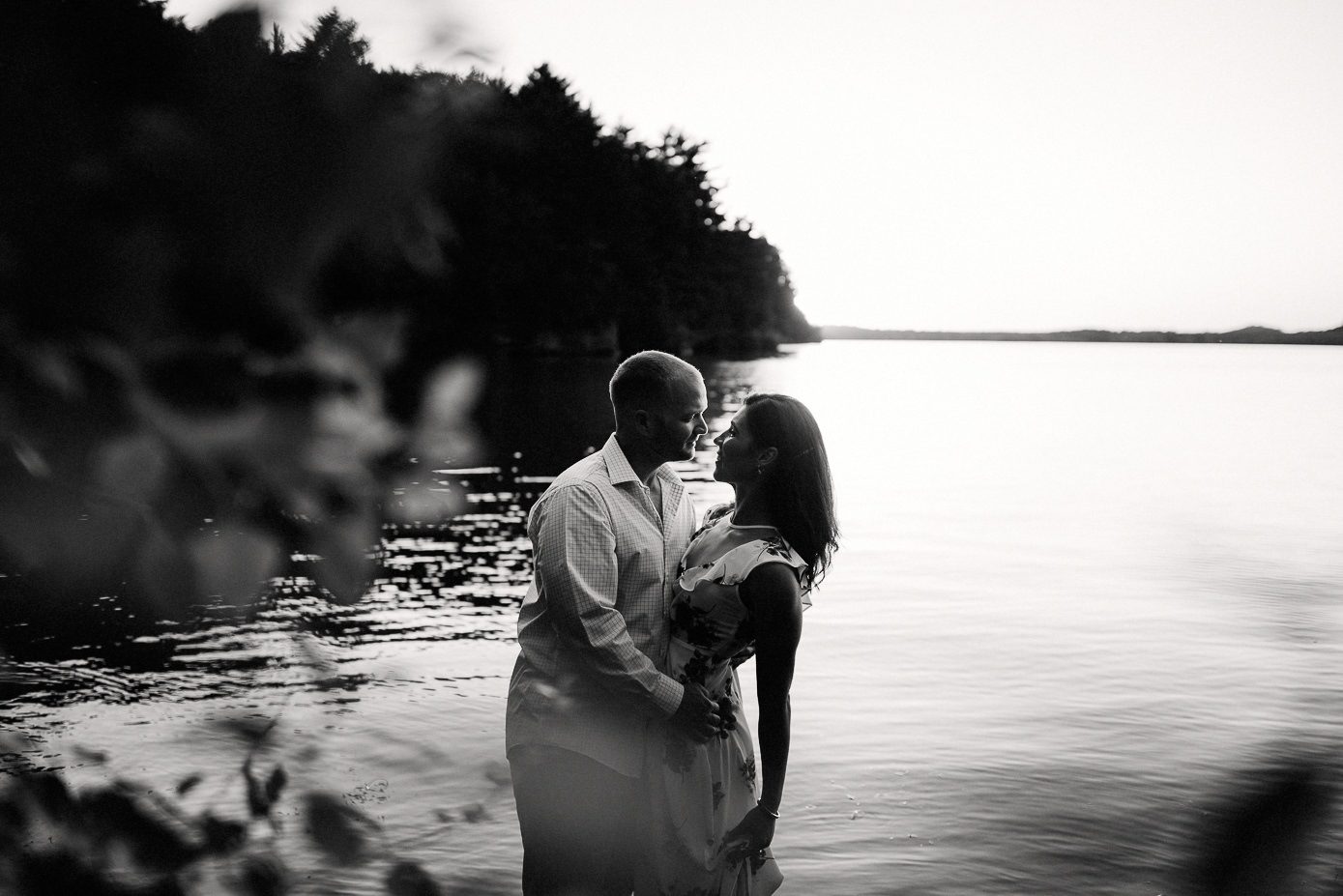 black and white photo of man dipping his wife
