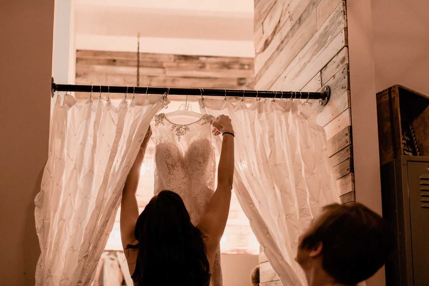 Bridesmaid getitng bridal gown for bride