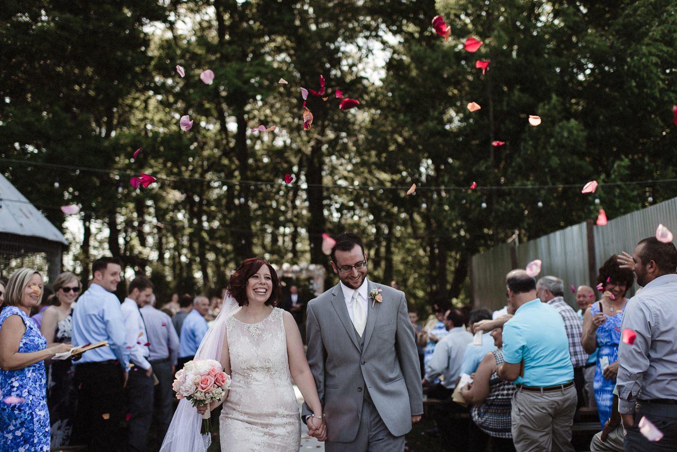 Guests tossing flower petals at wedding