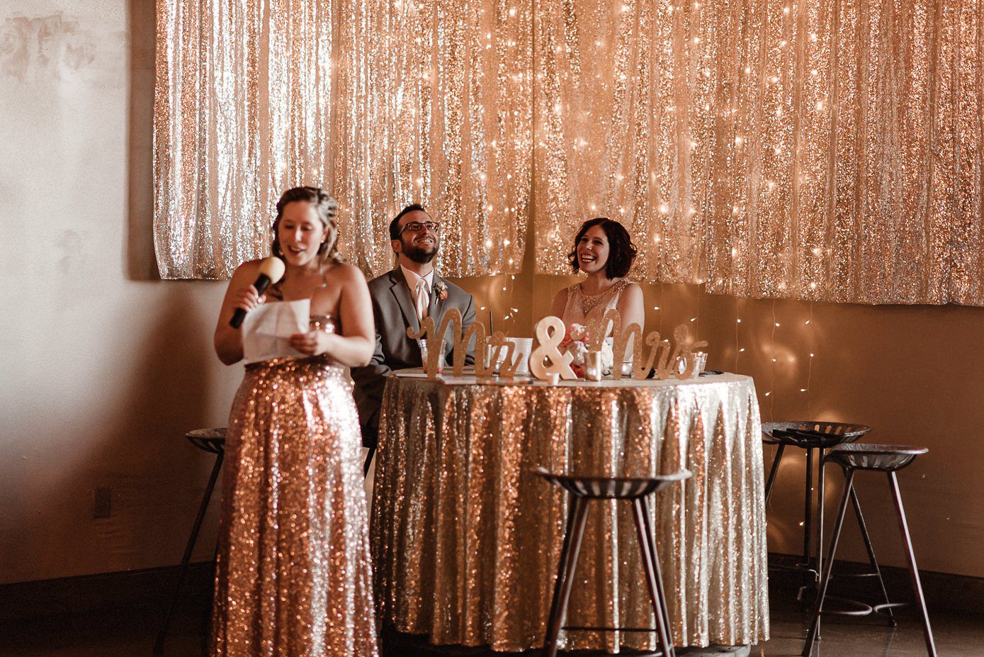 Sister giving toast to bride and groom