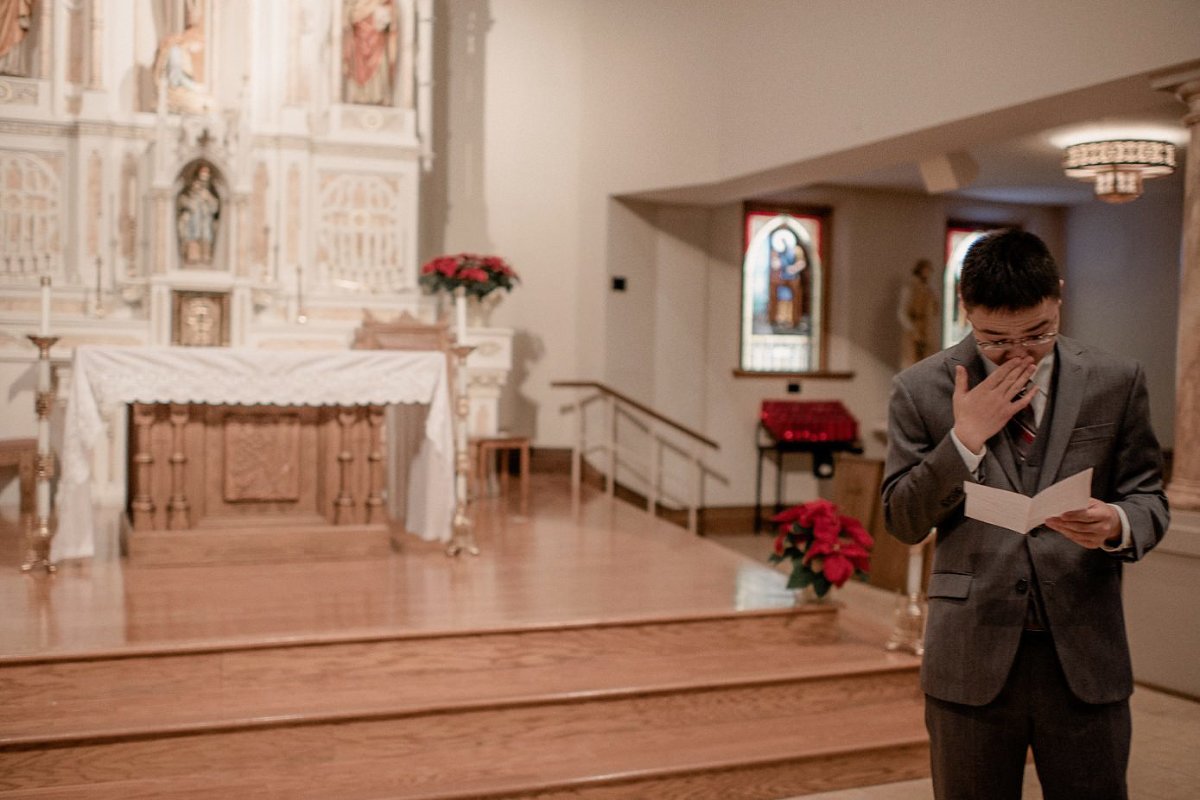 Groom crying while reading letter from his bride