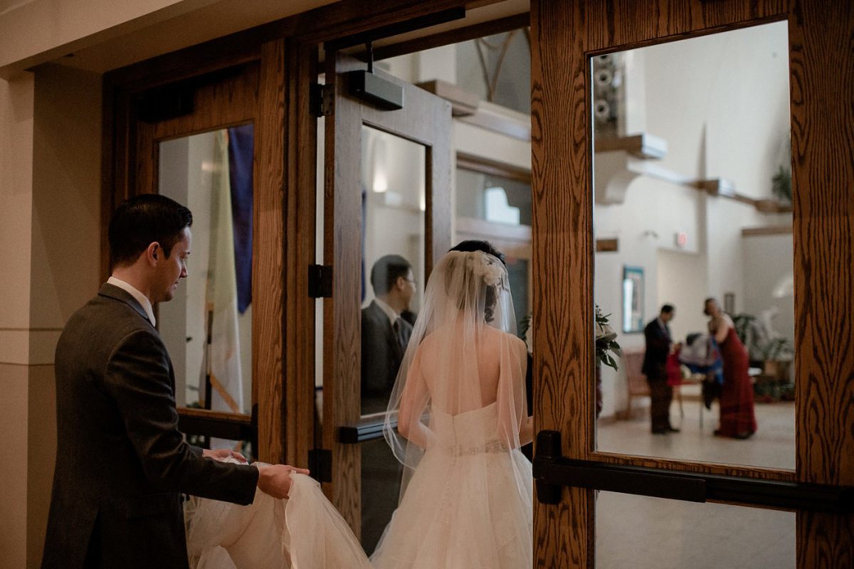 Brother helping sister with her dress