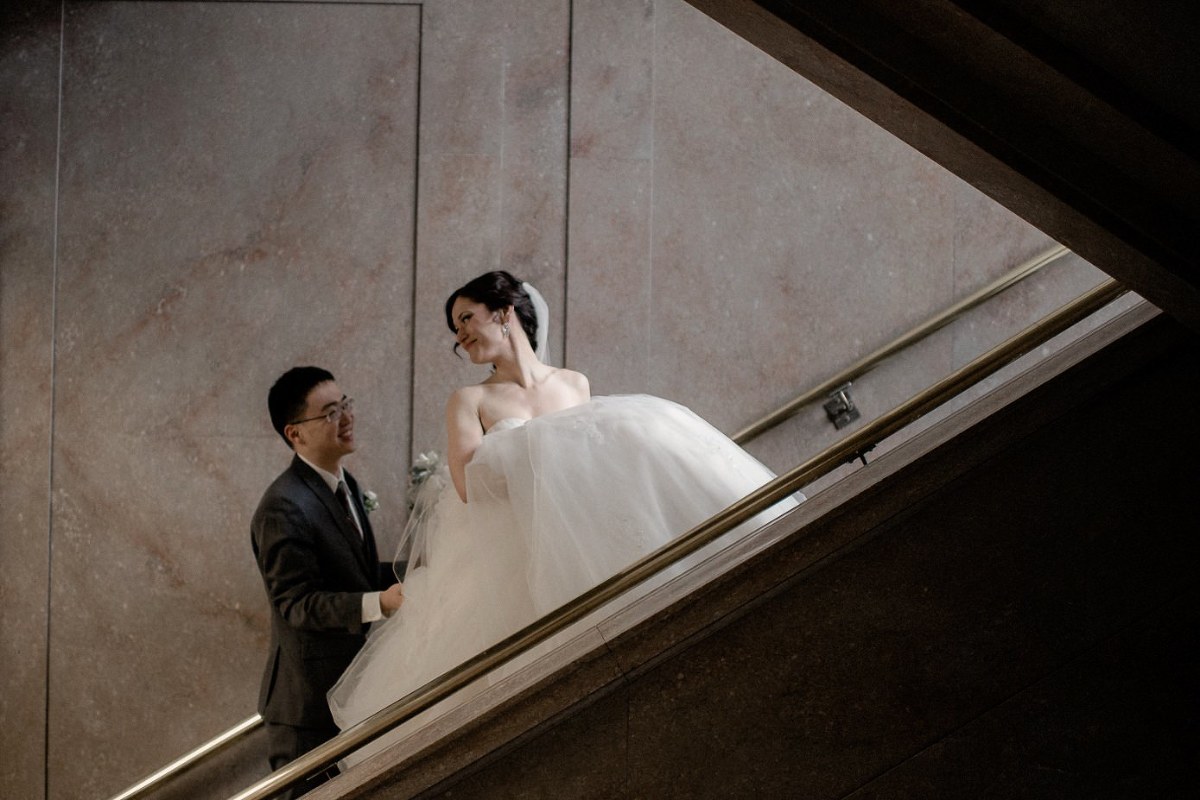 Bride and groom ascending stairs