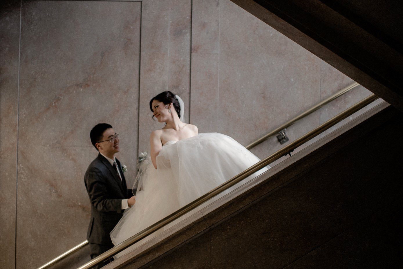 Bride and groom ascending stairs