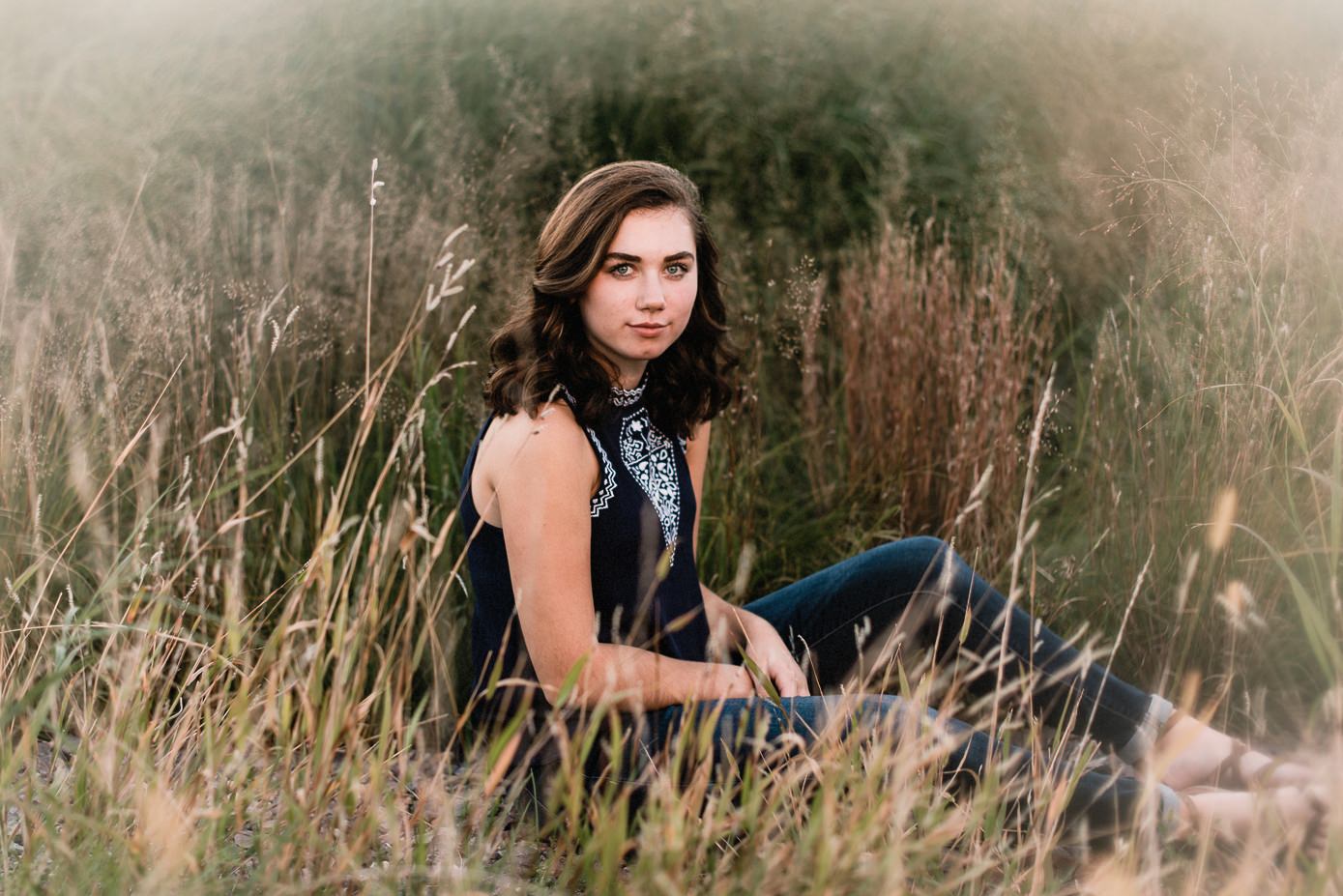 Senior pictures in grassy field