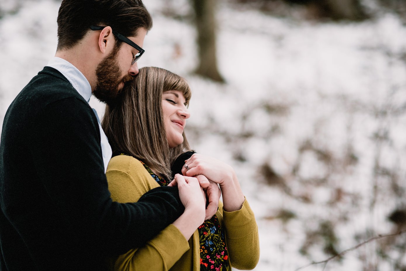 Couple snuggling during winter anniversary session