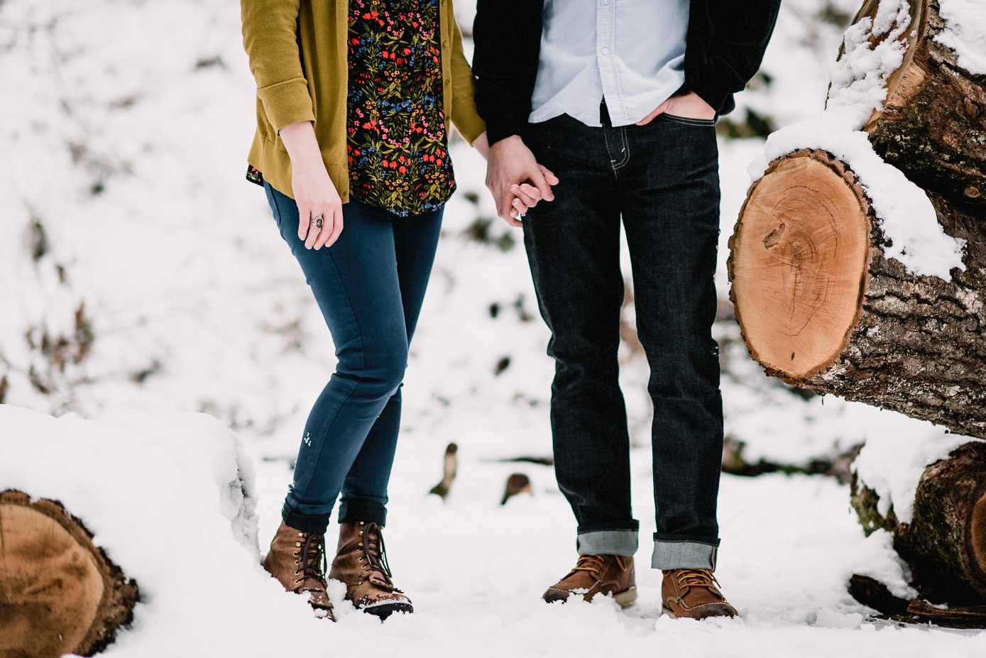 Couple standing hand in hand in snow