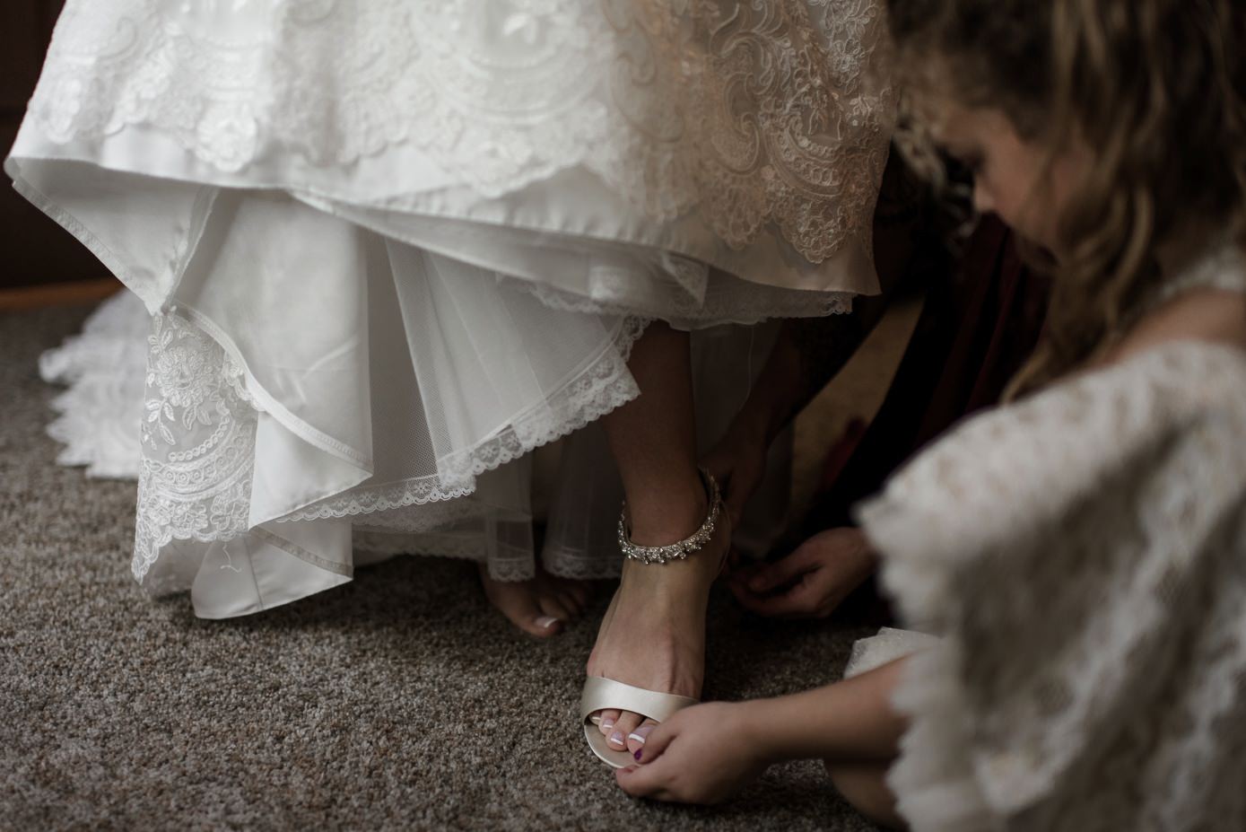 Bride getting into her wedding shoes