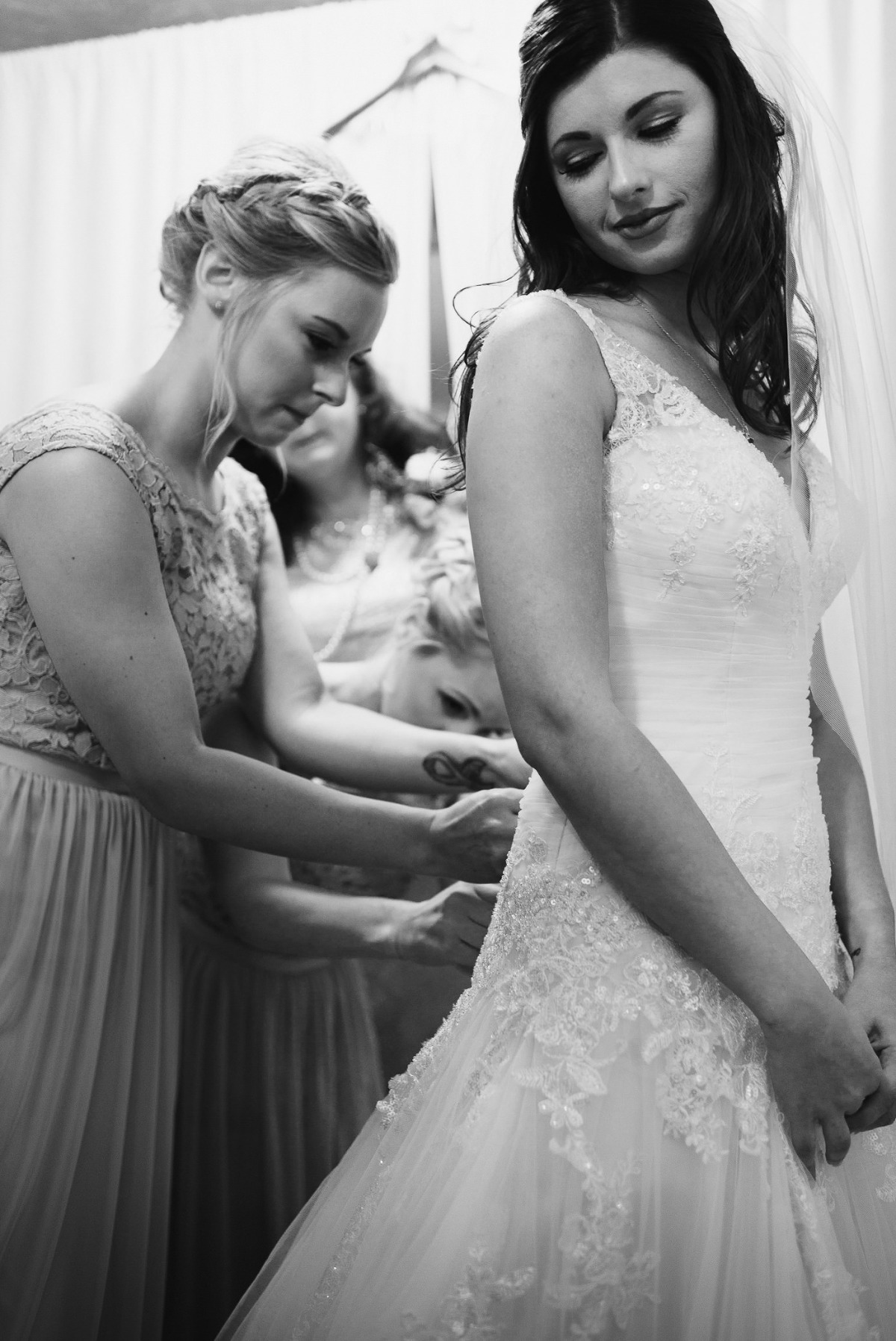 Bride getting into wedding dress at Barn Windy Pine.