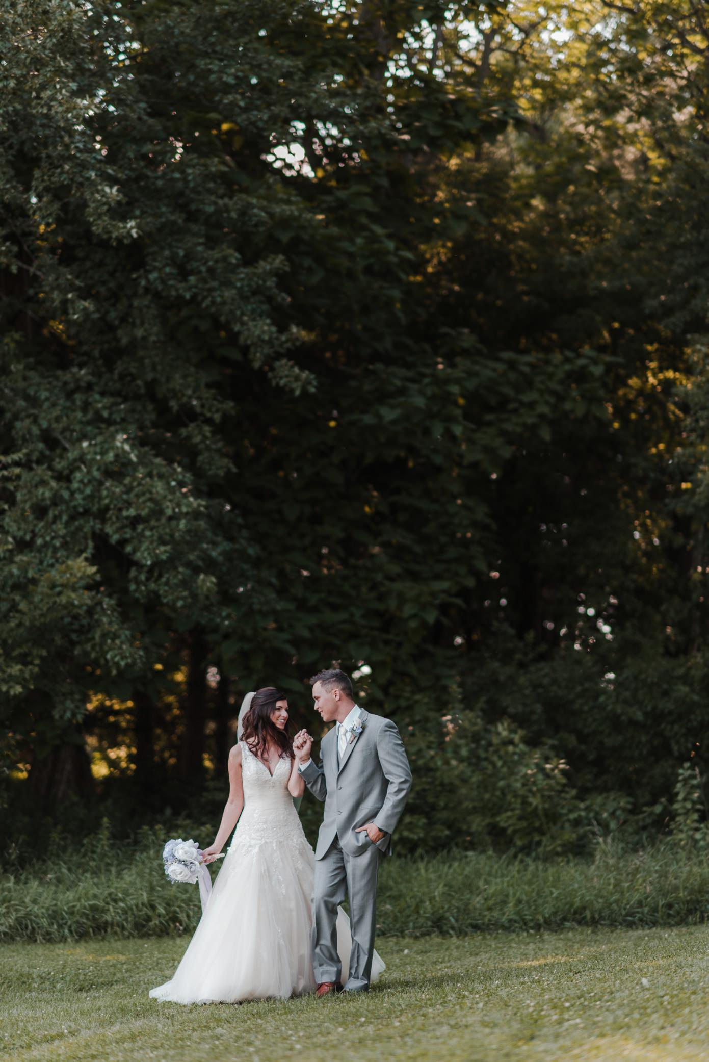 Couple walking at windy pine barn in Waterloo.