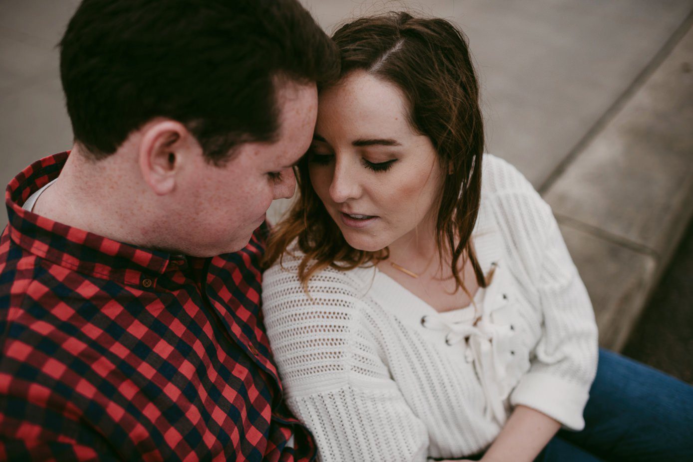 Couple snuggling during engagement session at Union Terrace