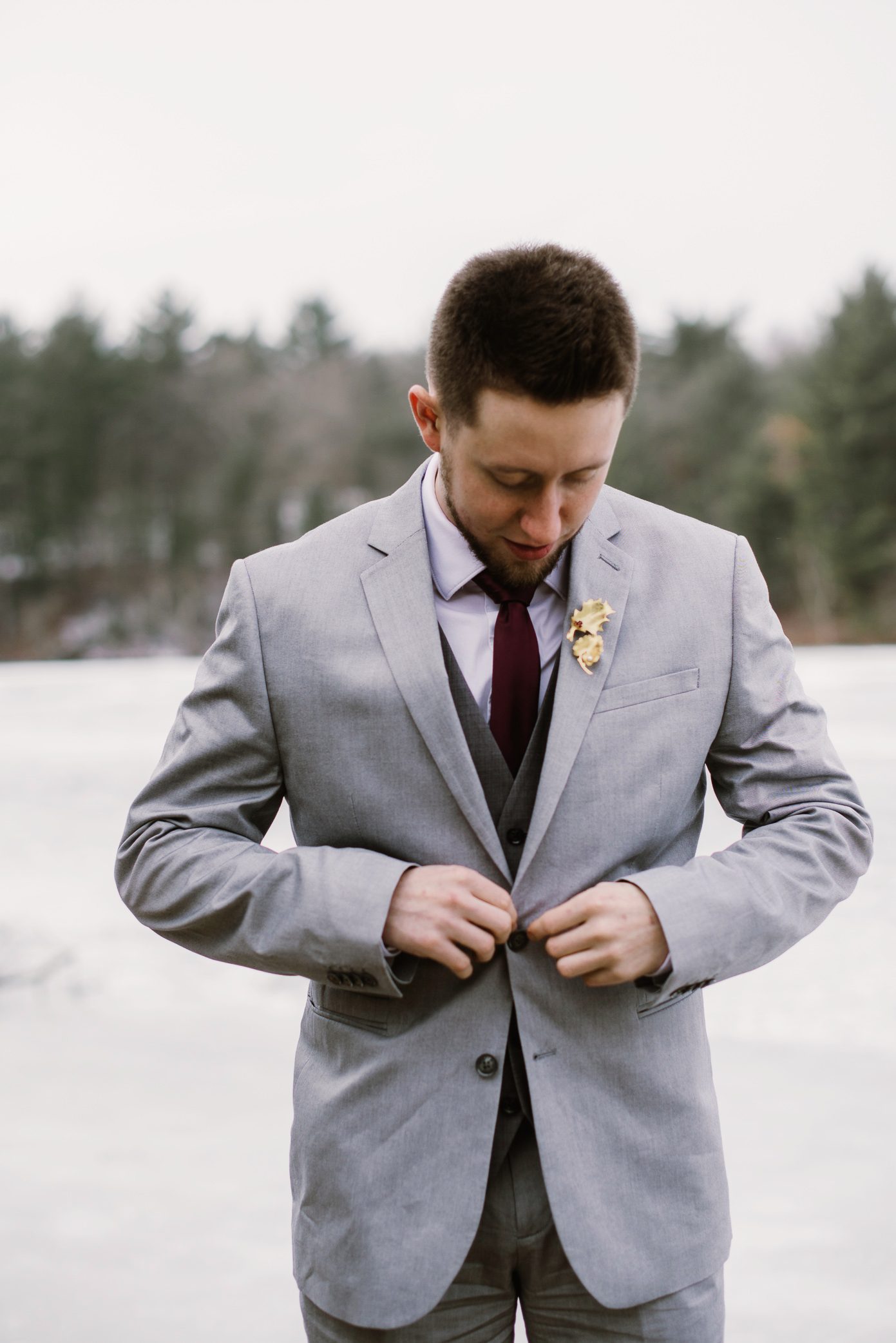 Groom buttoning jacket.