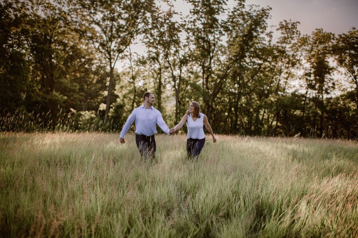 Madison engagement session with couple running in a field