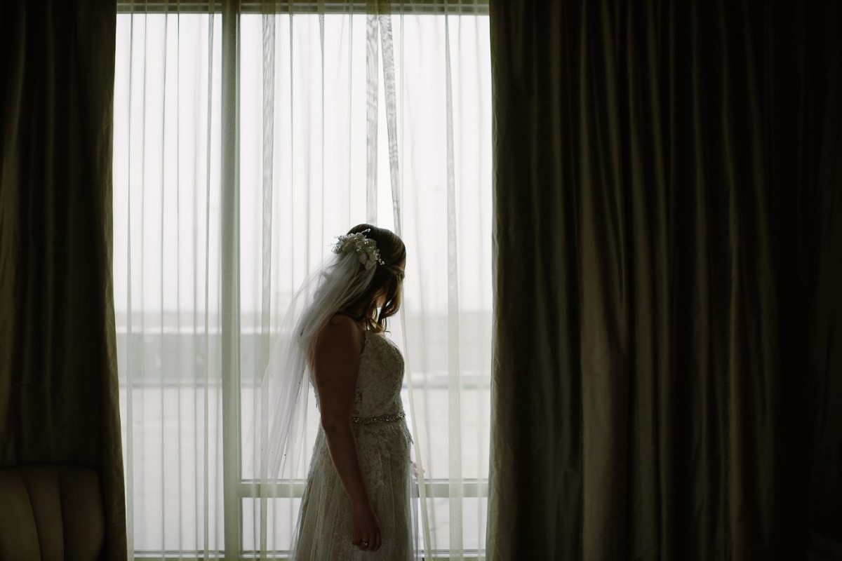 Milwaukee bride in front of window at The Westin Milwaukee