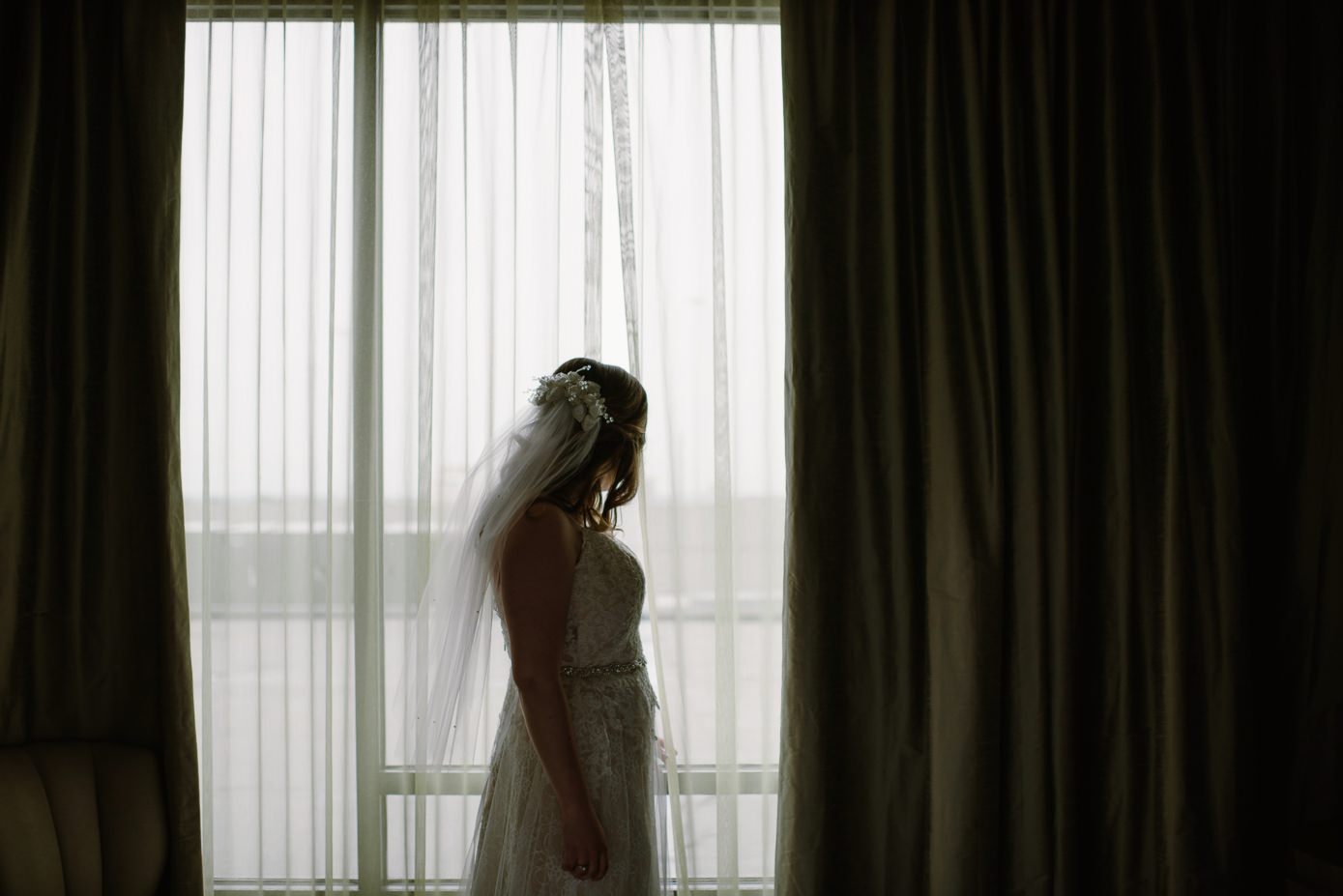 Milwaukee bride in front of window at The Westin Milwaukee