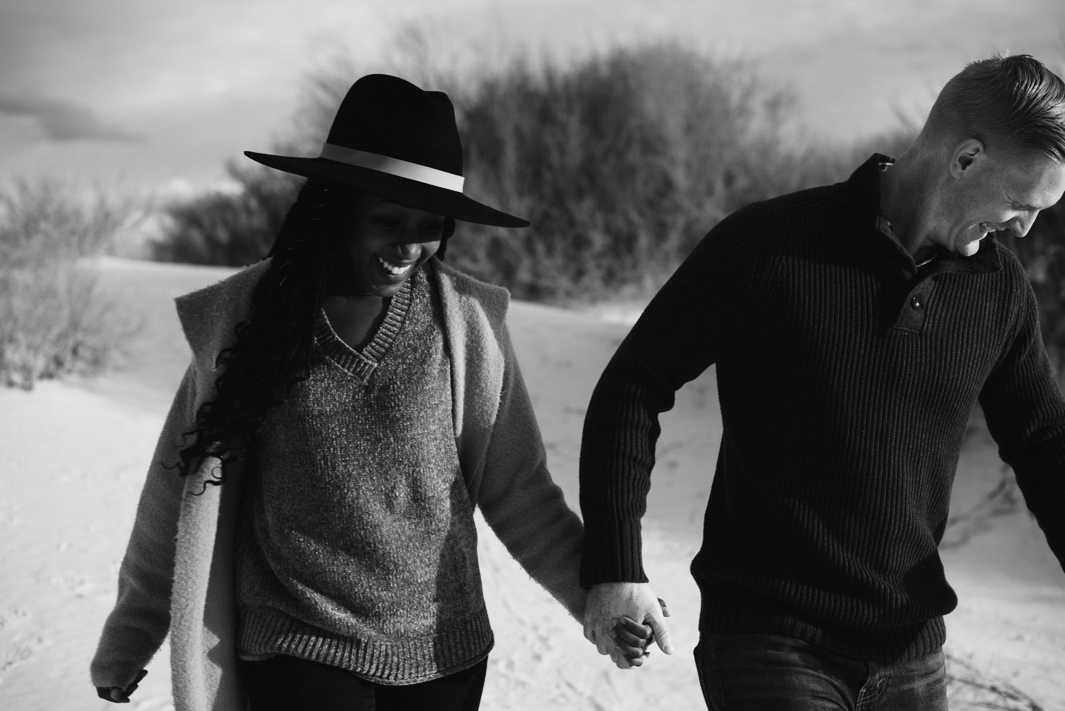 Lovers running in desert at White Sands