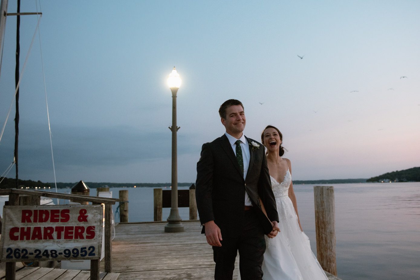 Happy wedding couple walking by the water in Lake Geneva