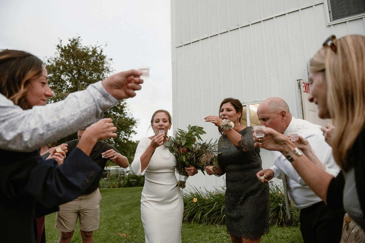 family taking tequila shots at wedding