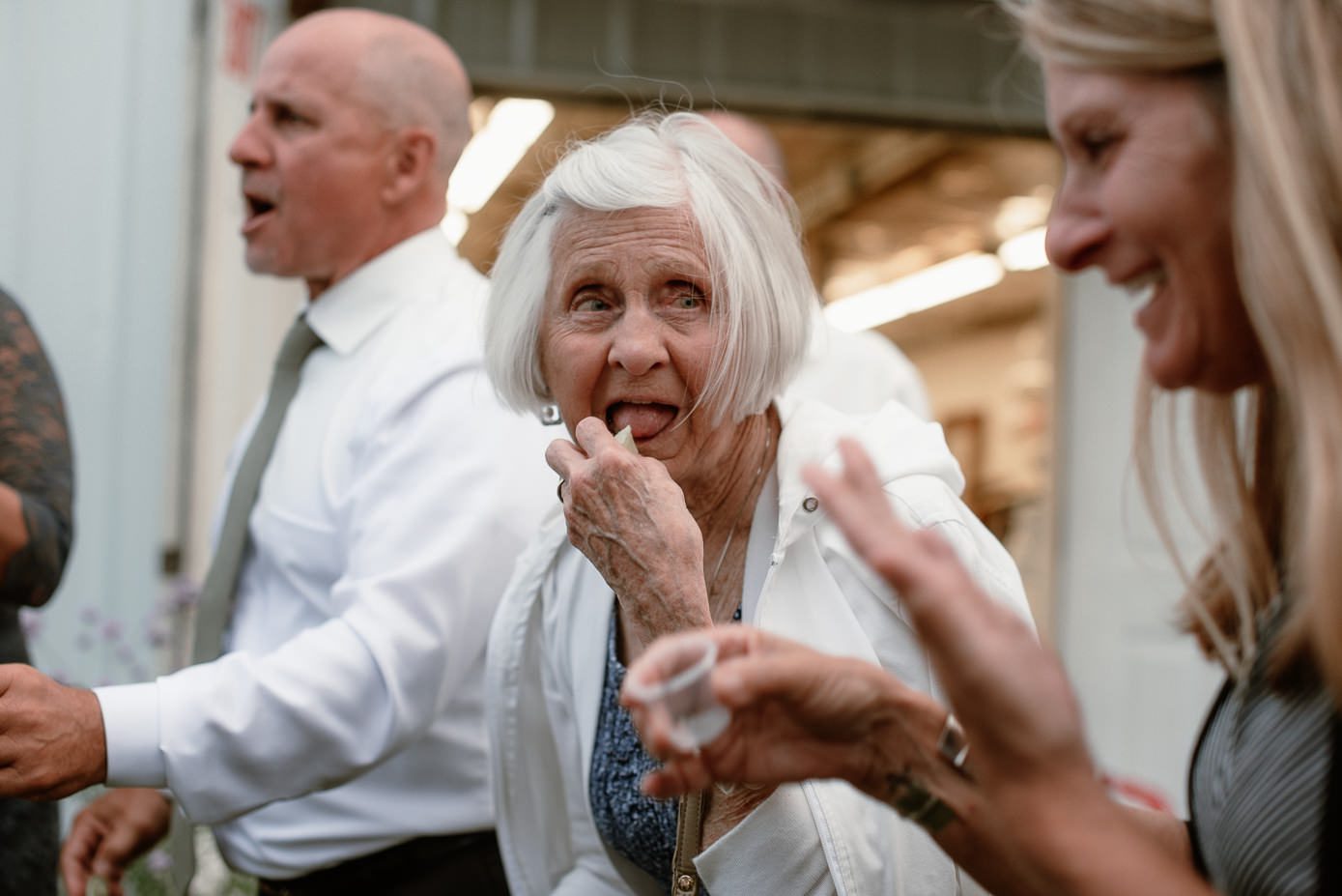 grandma taking shot of tequila at wedding