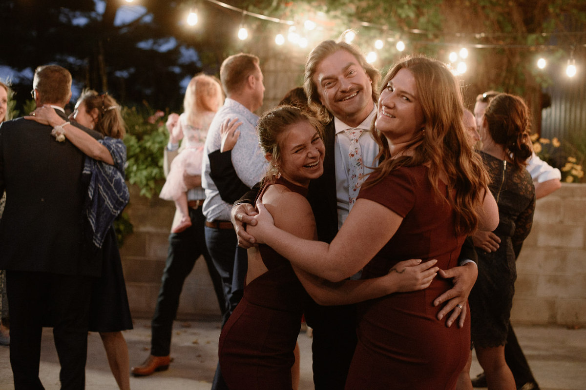 wedding party hugging on dancefloor