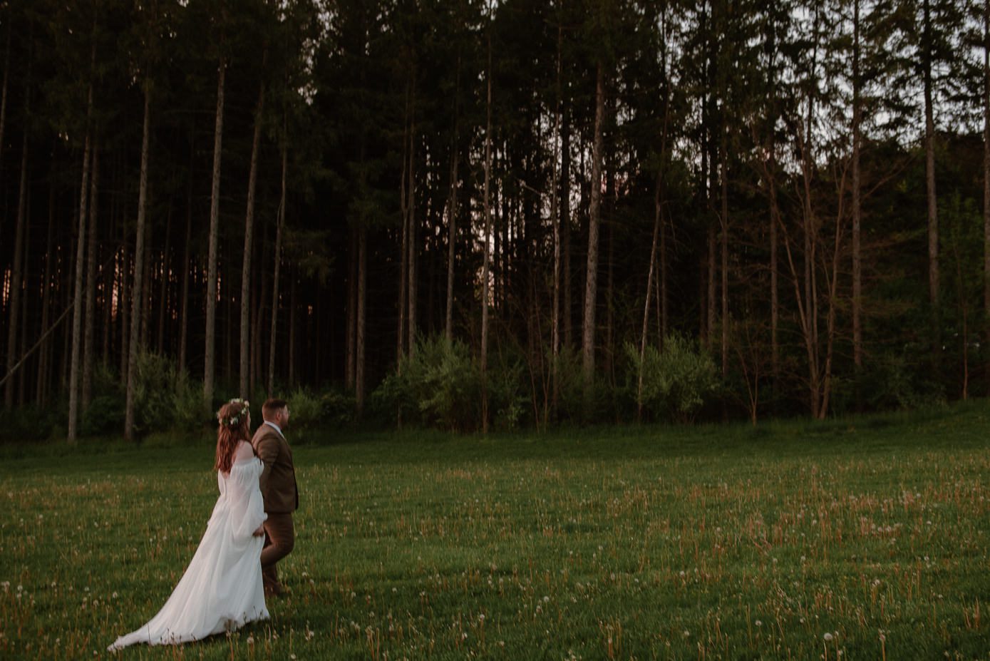 bride and groom walking at sunset at glacier hills county park wisconsin wedding venue.