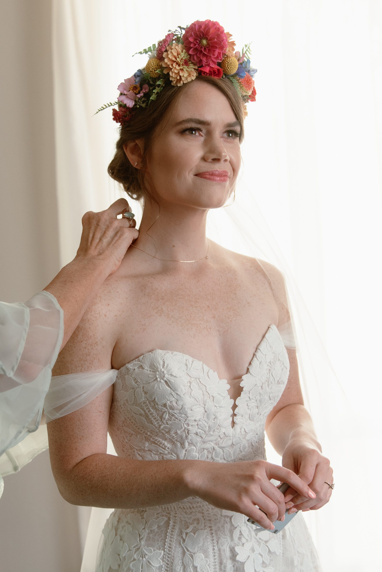 summer wedding where bride wore lace dress and colorful floral crown