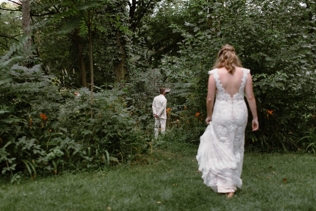 bride walking to the first look at camp wandawega wedding.