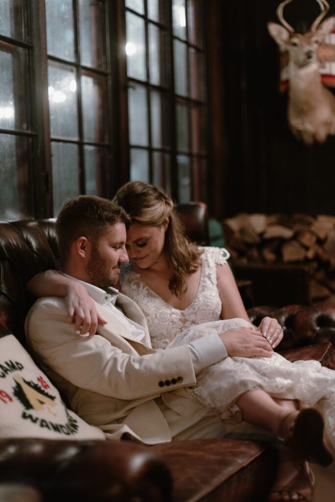 bride and groom snuggling inside camp wandawega lodge