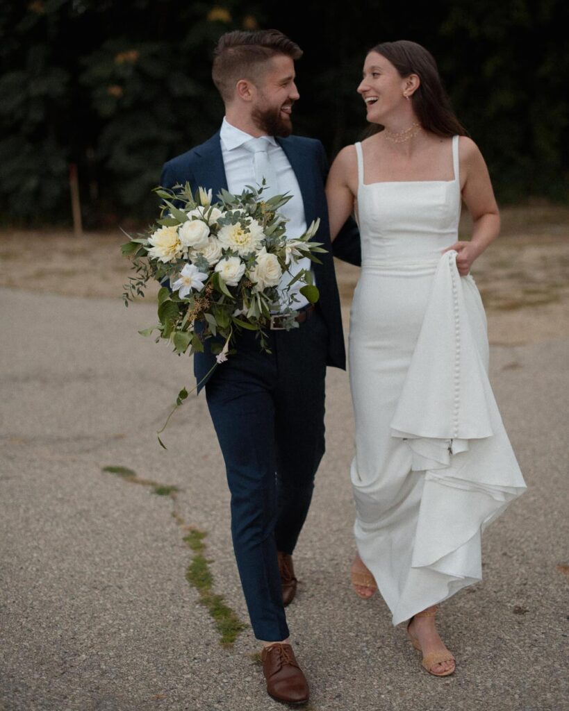 Candid portrait of bride and groom walking out The Lageret wedding venue