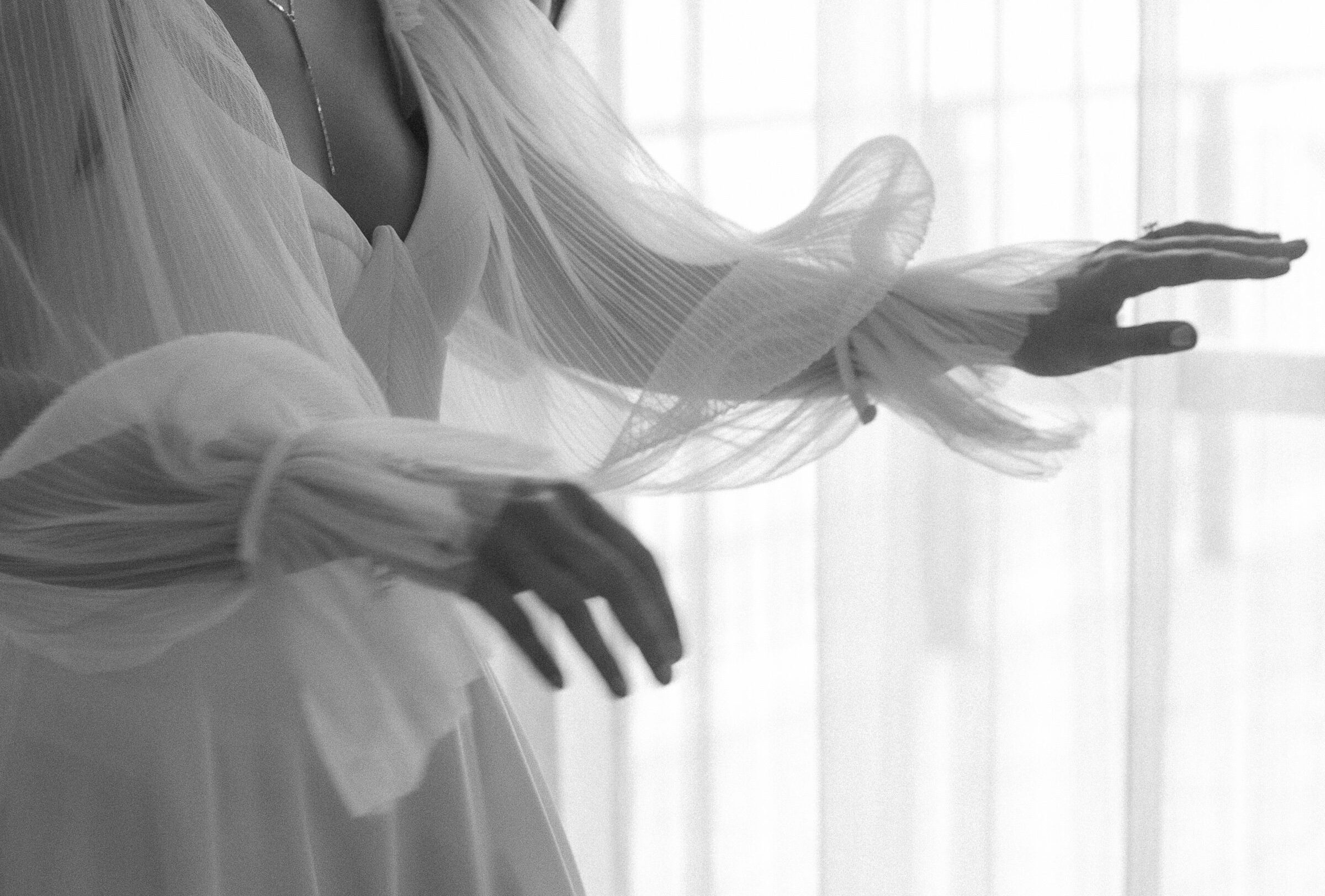 Bride putting on wedding dress at The Edgewater Hotel in Madison Wisconsin.